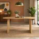 Orelvyn oval dining table for 6 with a natural solid wood finish and sculpted curved wooden legs