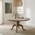 Thalvique weathered oak round dining table made from solid wood with a sculptural pedestal base.