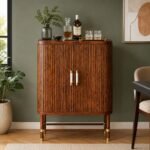 Tharvessio solid wood bar cabinet in rich brown finish with vertical detailing, metallic handles, and raised frame